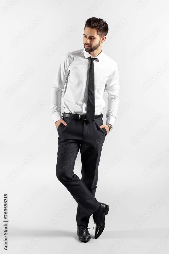 Fashionable young man on grey background