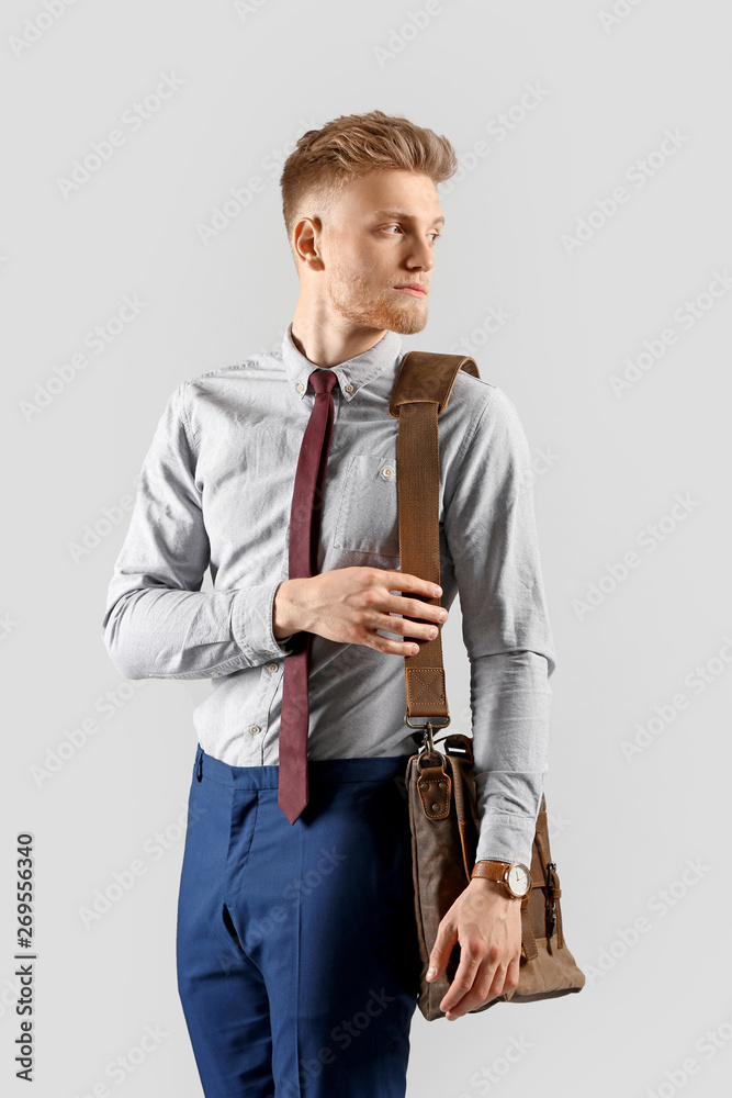 Fashionable young man on grey background