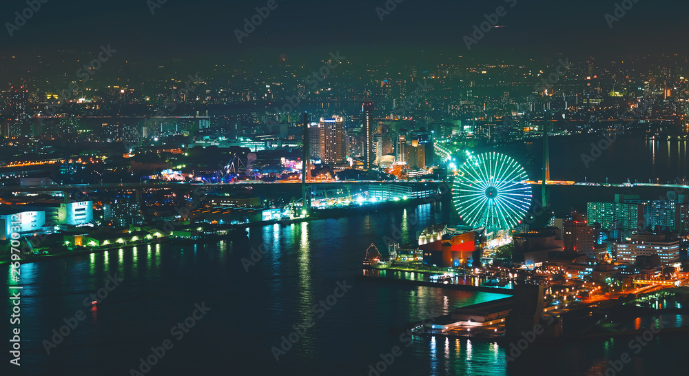 Aerial view of the Osaka Bay harbor area with the ferris wheel at night