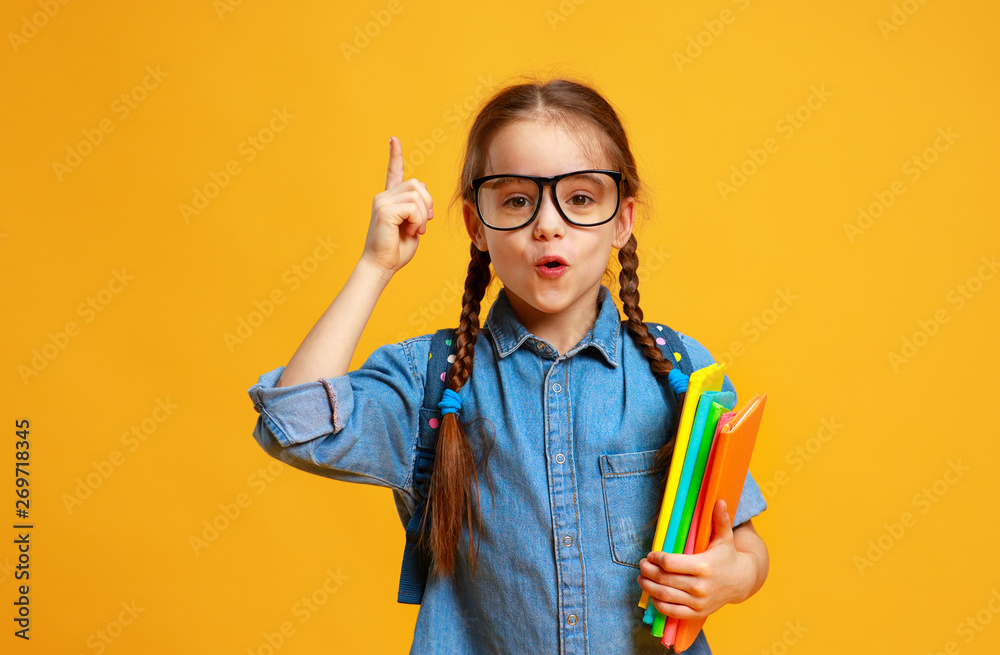 funny child school girl girl on yellow background    .