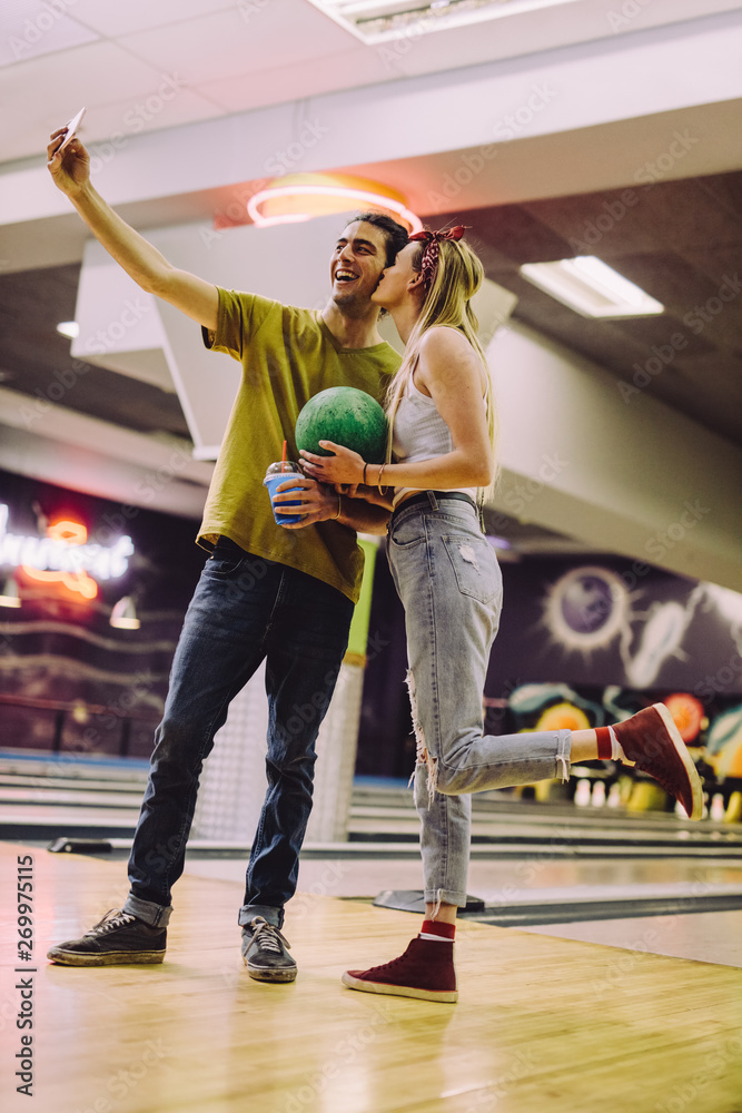 Couple taking selfie of at bowling club