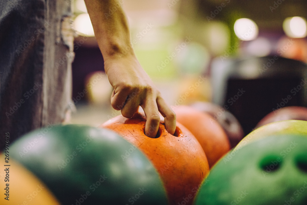 Hand choosing a bowling bowl