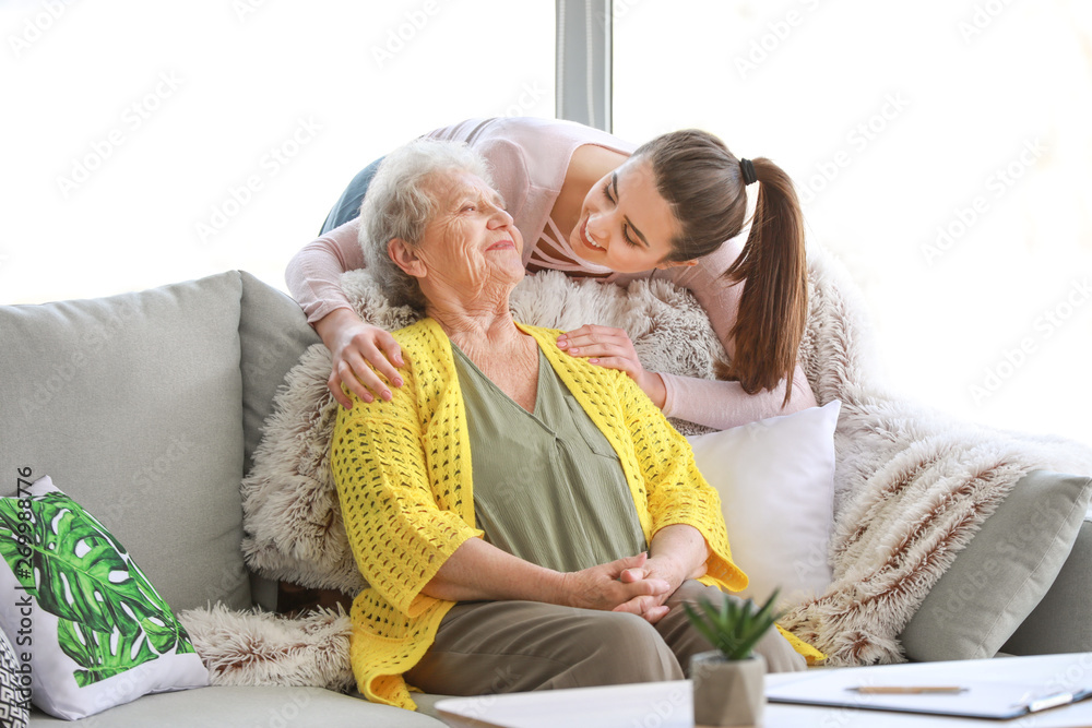 Caregiver with senior woman in nursing home