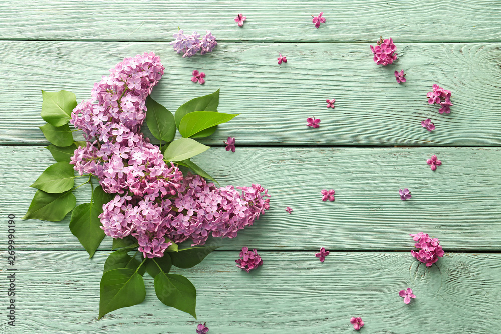 Beautiful lilac flowers on wooden background