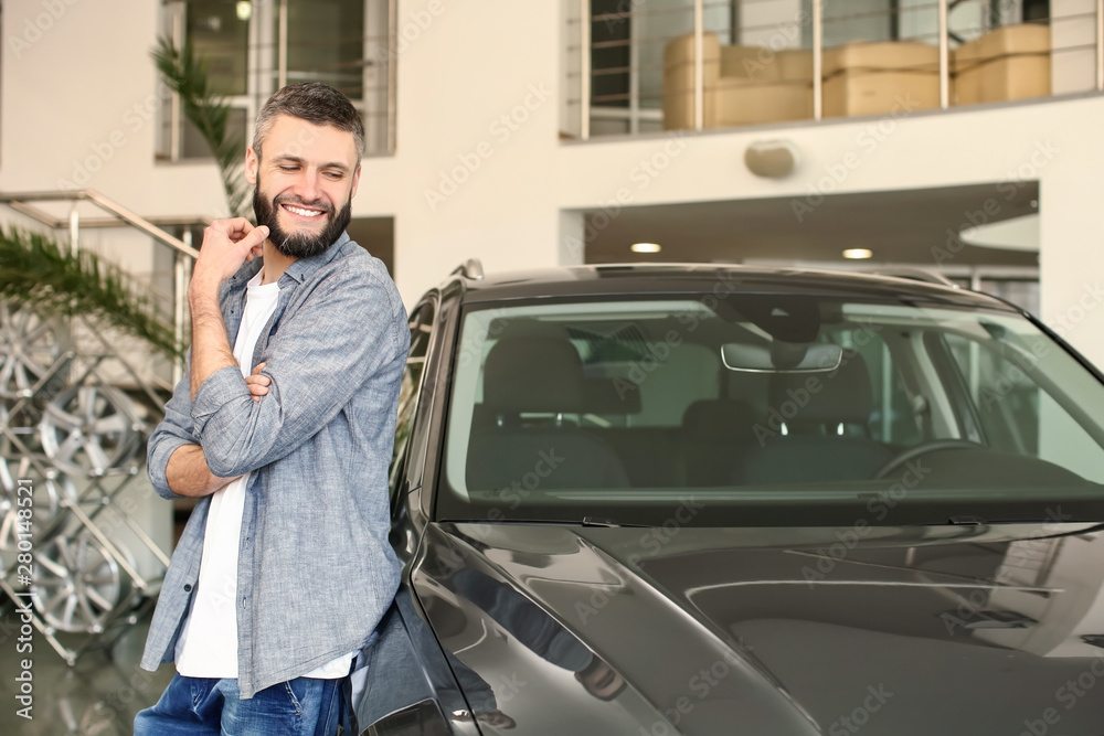 Man choosing new car in salon