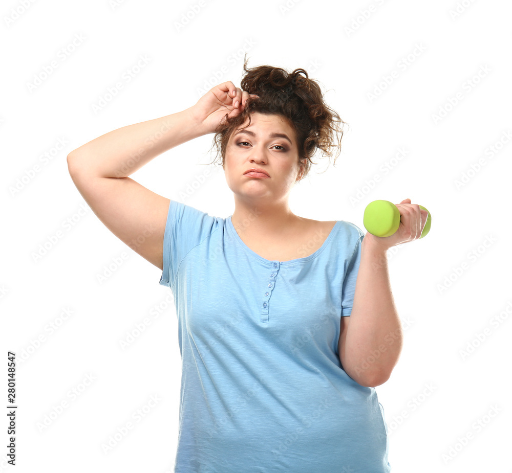 Tired overweight woman with dumbbell on white background