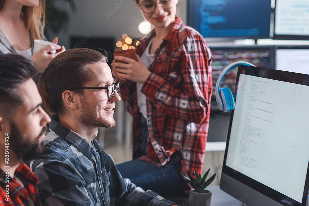 Team of programmers working in office