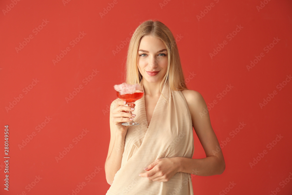 Beautiful woman with cotton candy cocktail on color background