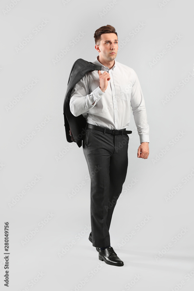 Fashionable young man on grey background