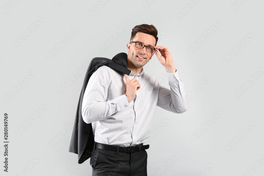 Fashionable young man on grey background