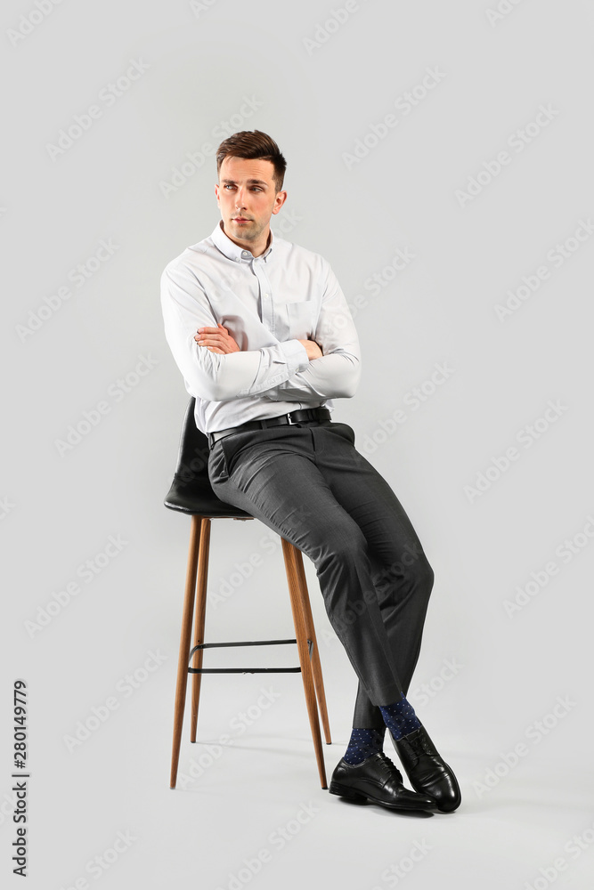 Fashionable young man on grey background