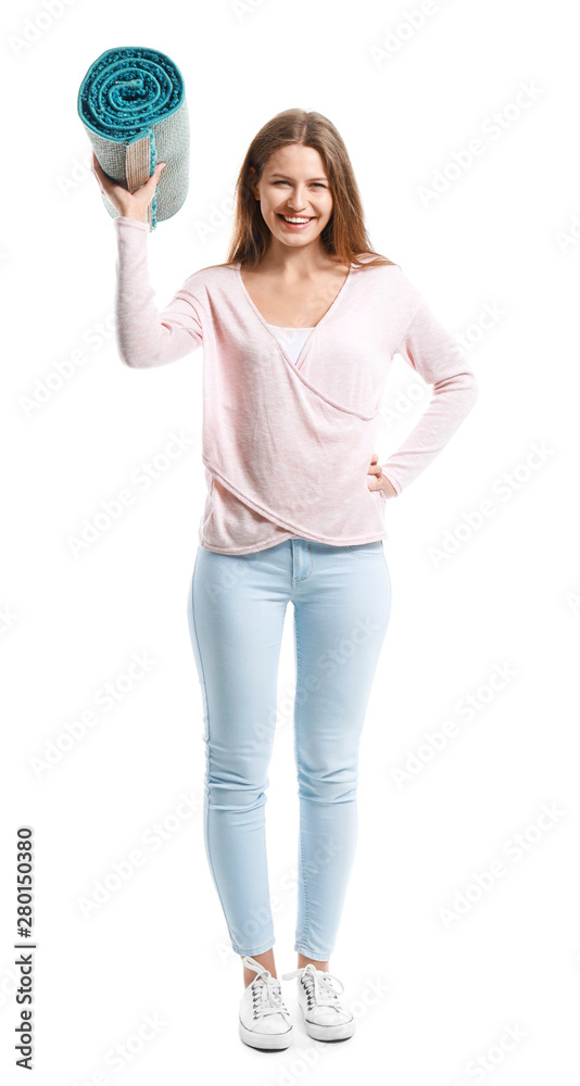 Young woman holding rolled carpet against white background