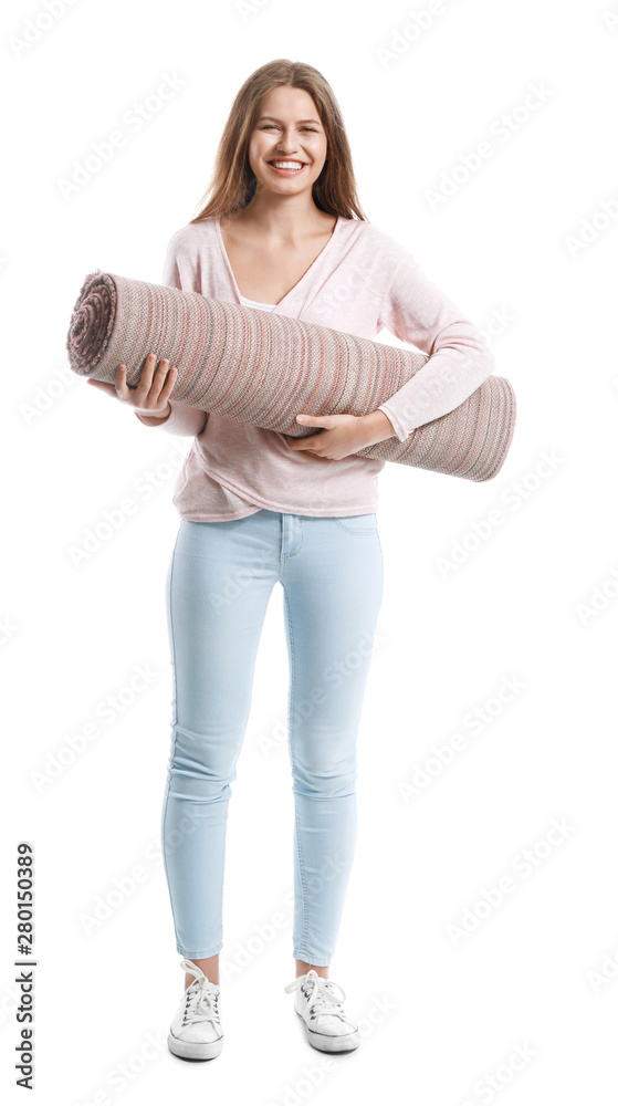 Young woman holding rolled carpet against white background