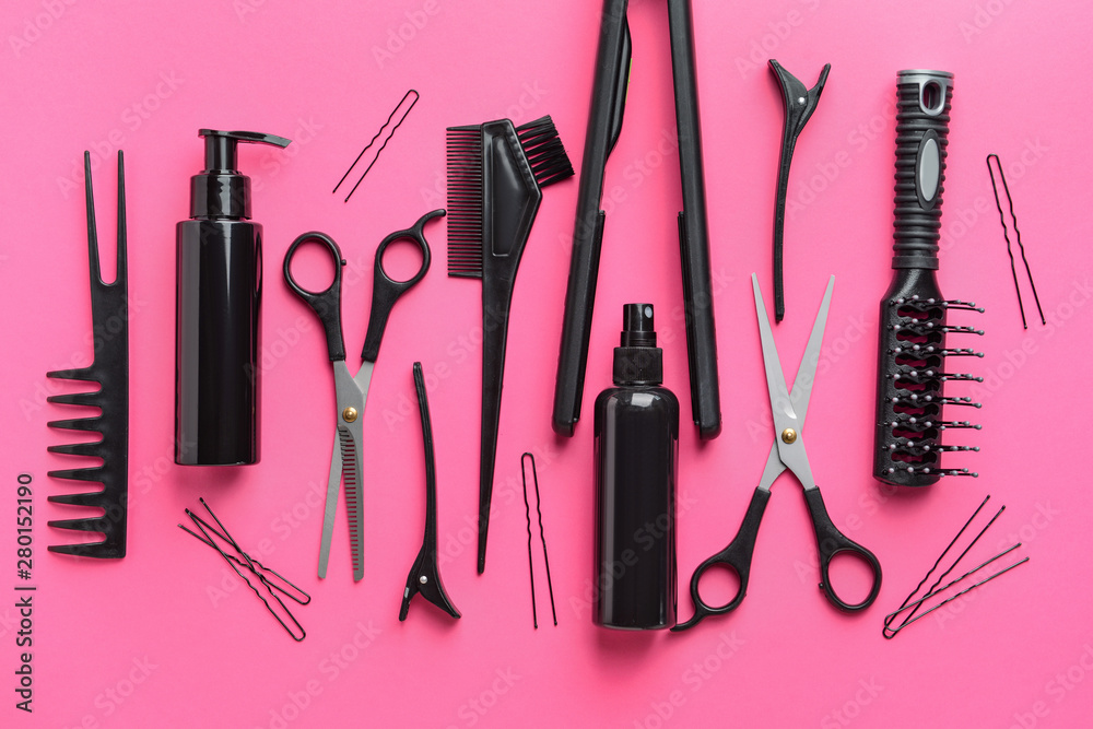 Set of hairdresser tools and accessories on color background