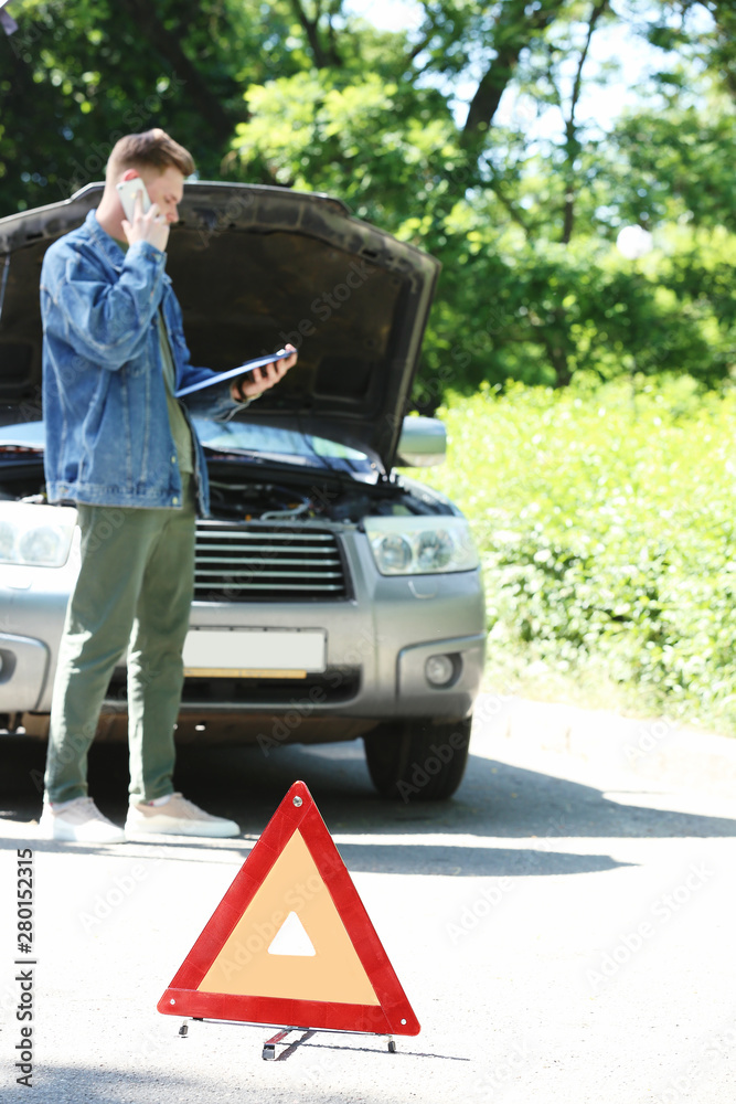 Insurance agent inspecting car after accident