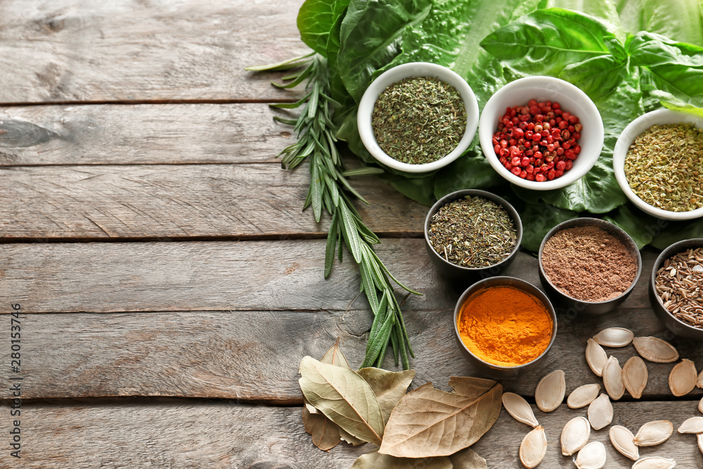 Different herbs and spices on wooden background