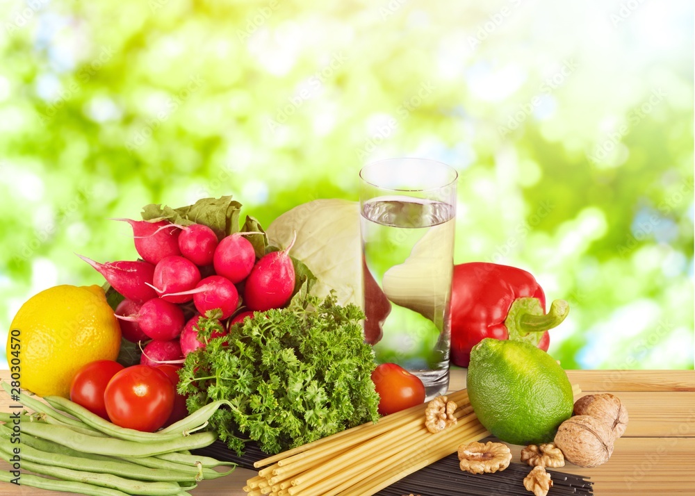 Fresh tasty vegetables with water on background