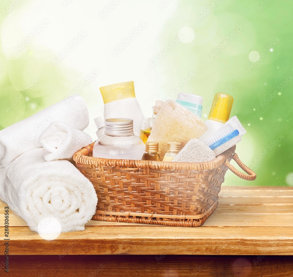 Bath towel and basket with accessories for spa on blur background