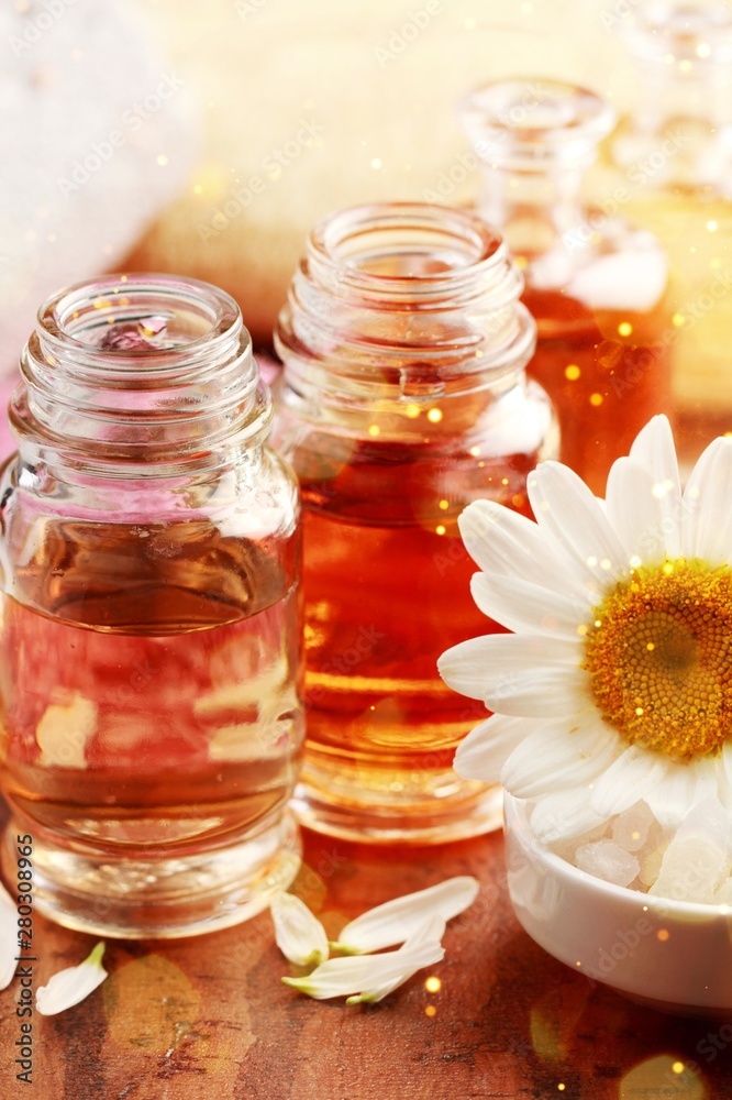 Healthy spa concept with perfume and oil bottles and flowers