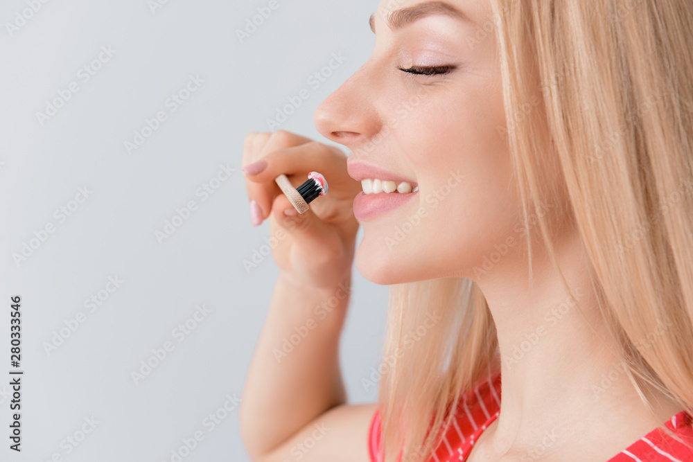 Woman with toothbrush on light background. Concept of dental hygiene