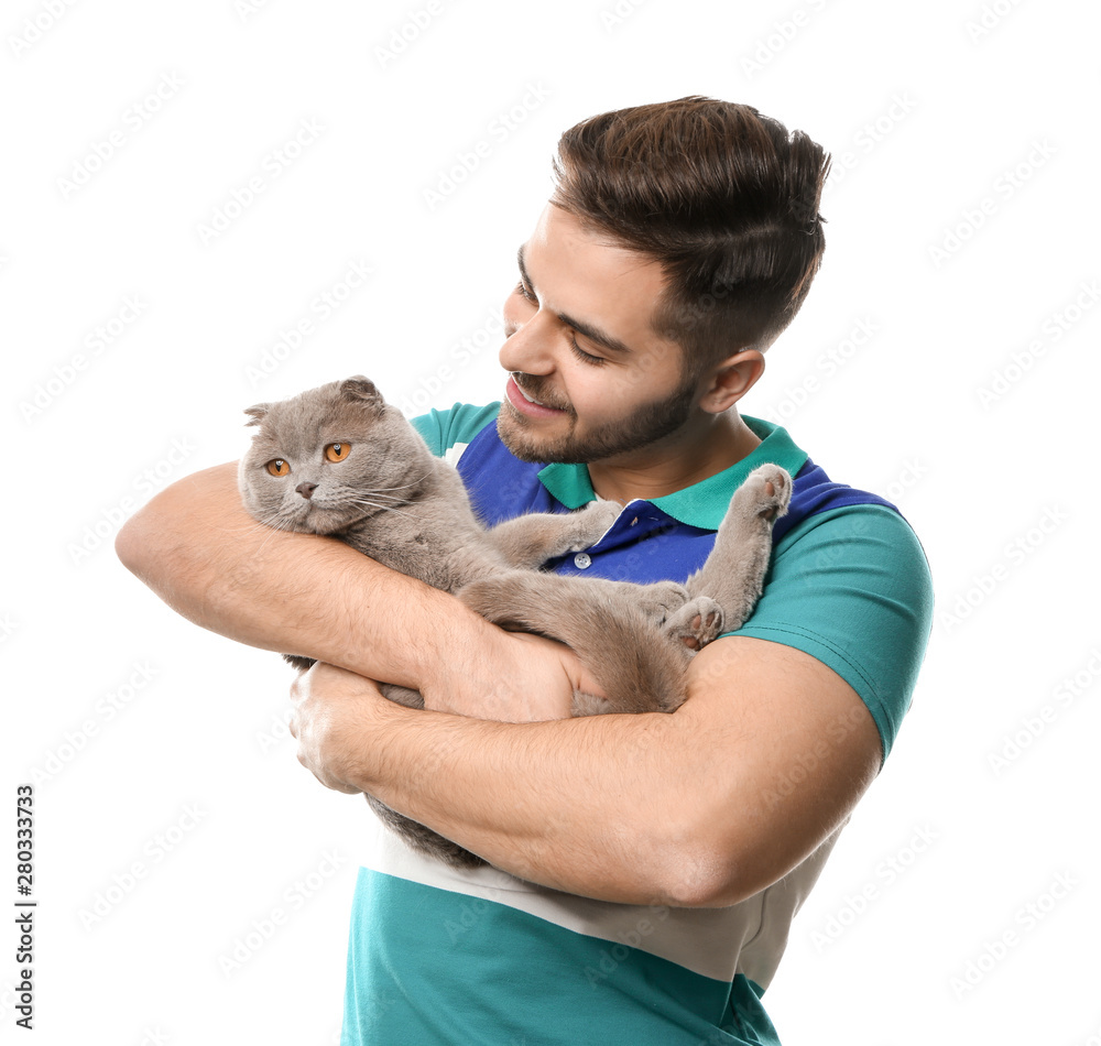 Young man with cute funny cat on white background