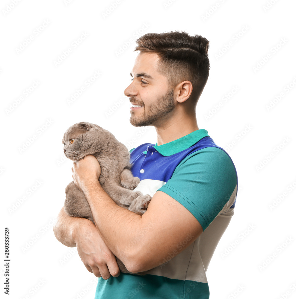 Young man with cute funny cat on white background