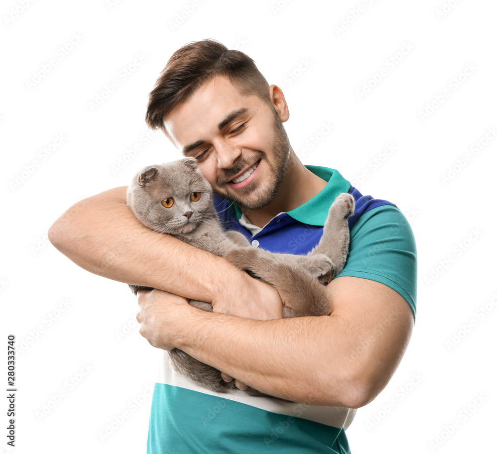 Young man with cute funny cat on white background