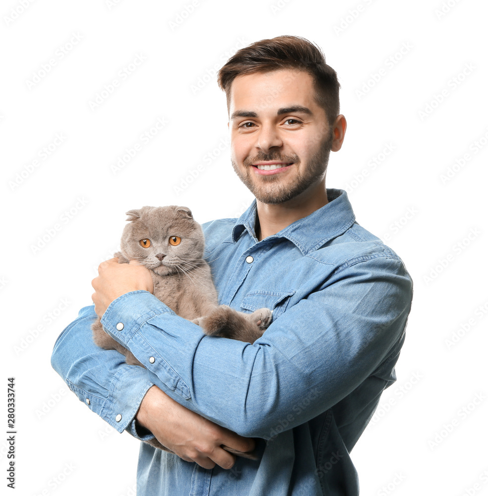 Young man with cute funny cat on white background