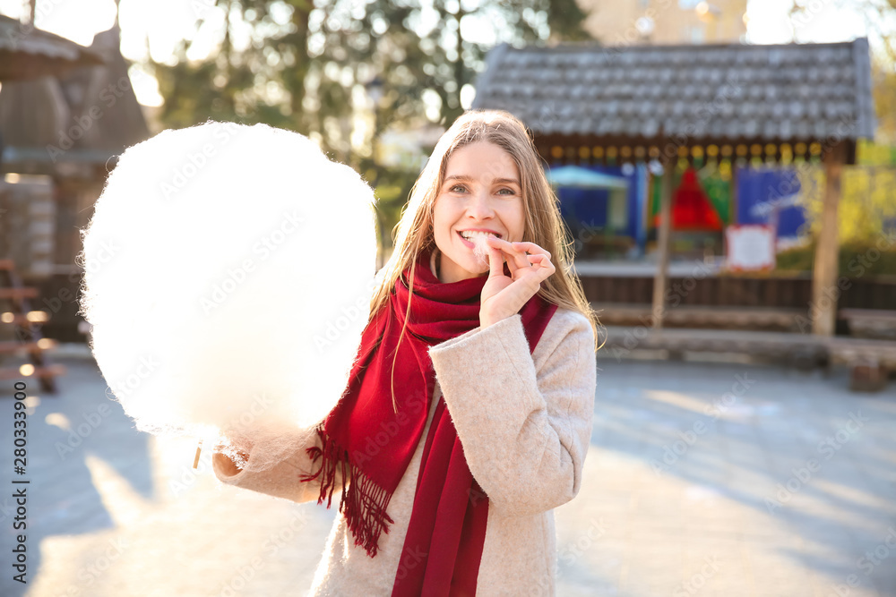 Woman with sweet cotton candy outdoors