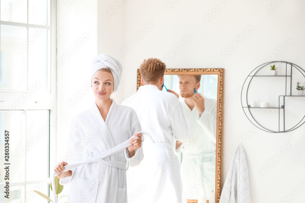 Morning of happy young couple in bathroom