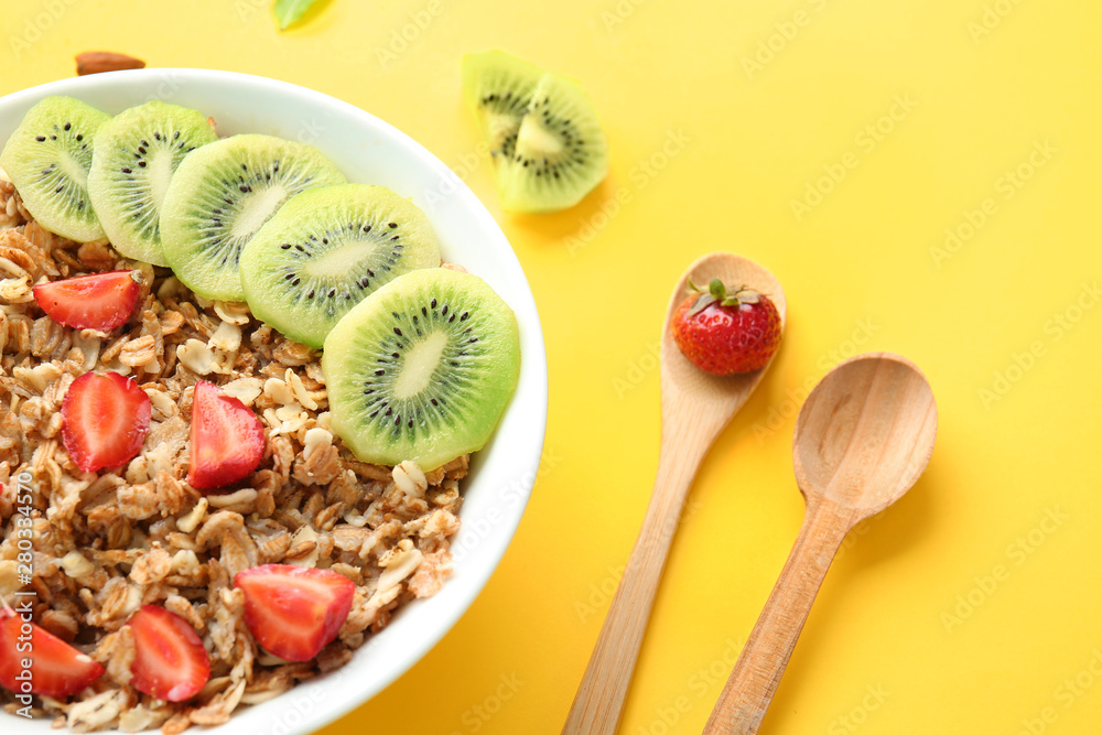 Bowl with tasty sweet oatmeal on color background