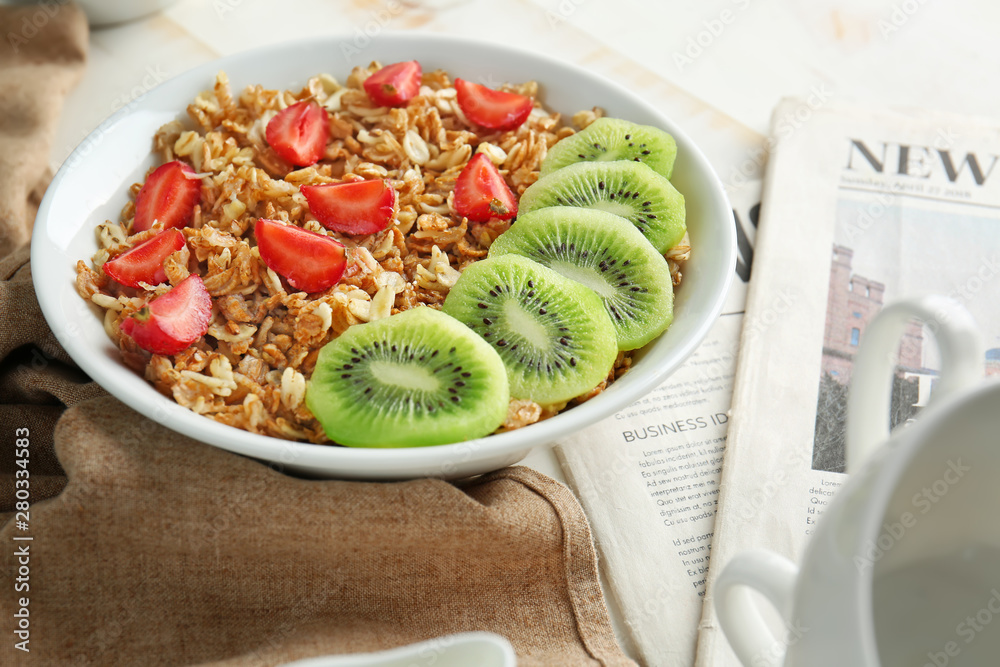 Bowl with tasty sweet oatmeal on table