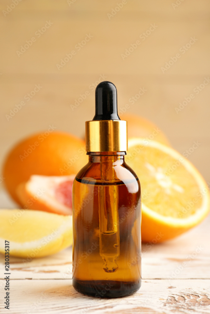 Bottle of citrus essential oil on table