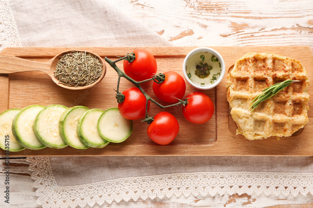 Tasty squash waffles with vegetables on wooden table