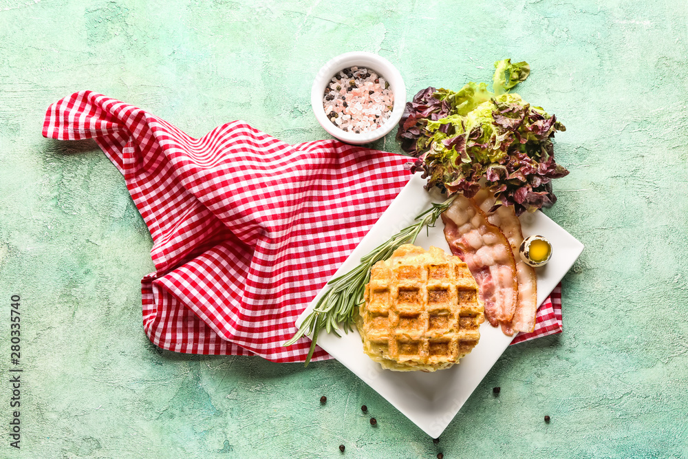 Plate with tasty squash waffles and fried bacon on table