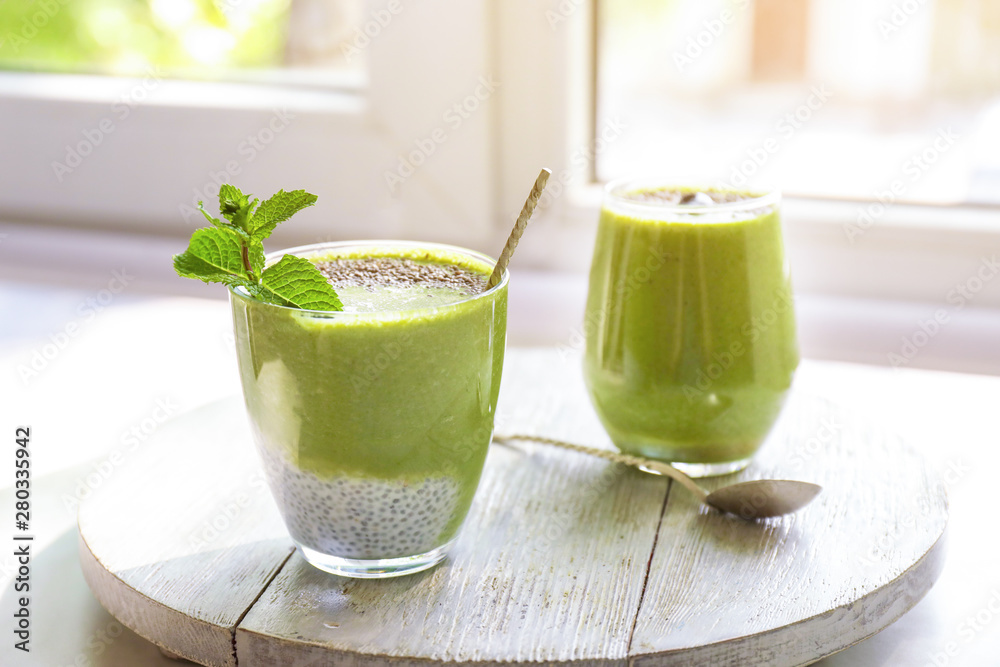 Glasses of healthy smoothie on window sill