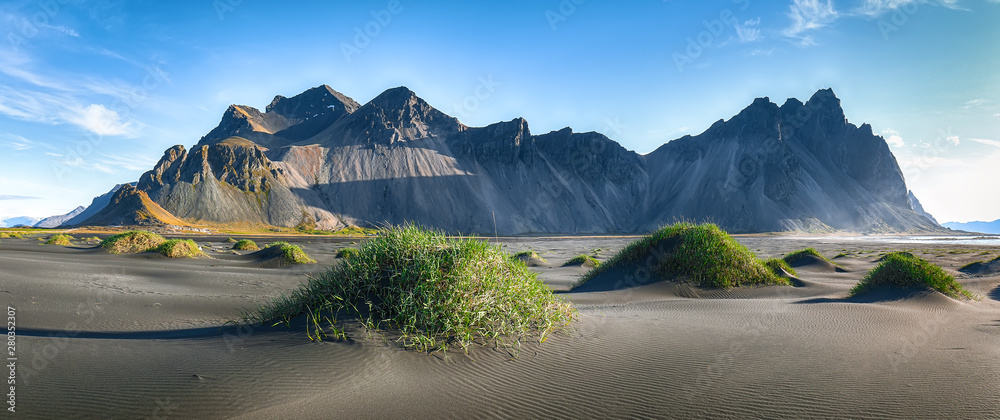 Fantastic sunny day and gorgeous black sand dunes on Stokksnes cape in Iceland.