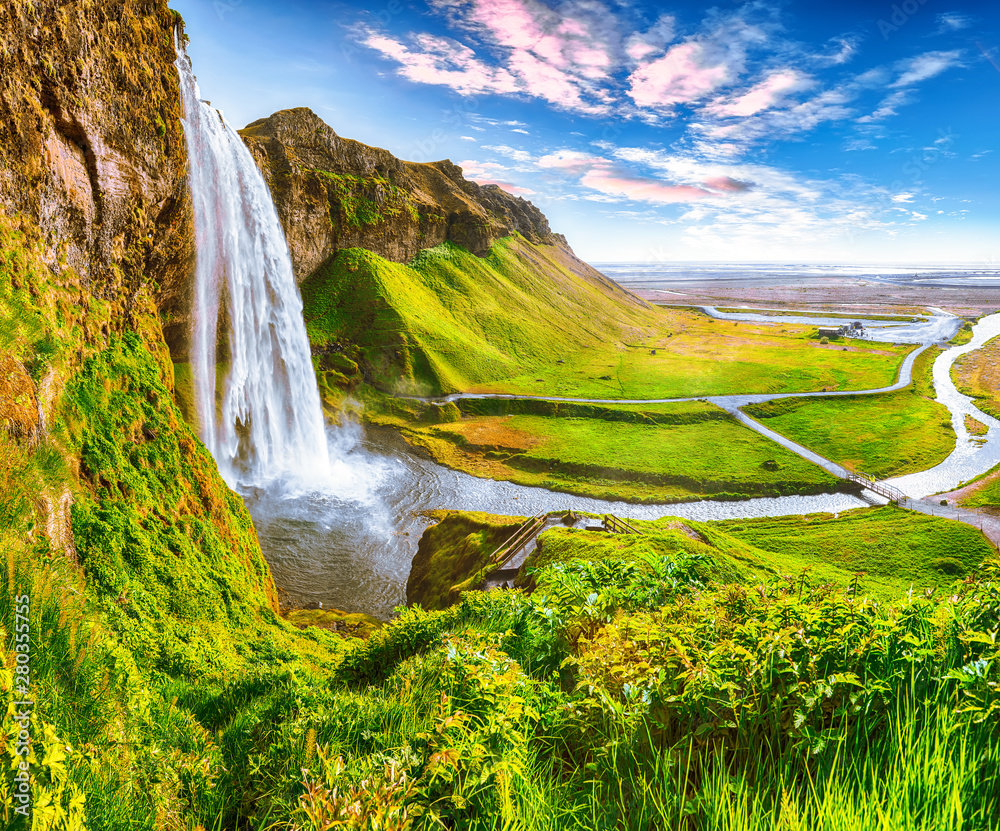 Beautiful scenery of the majestic Skogafoss Waterfall in countryside of Iceland in summer.