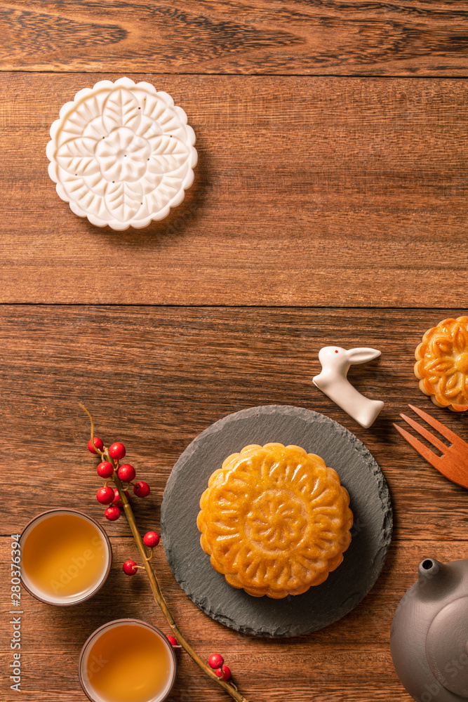 Creative Moon cake Mooncake table design - Chinese traditional pastry with tea cups on wooden backgr