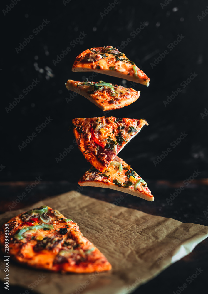 Levitation pizza on black background