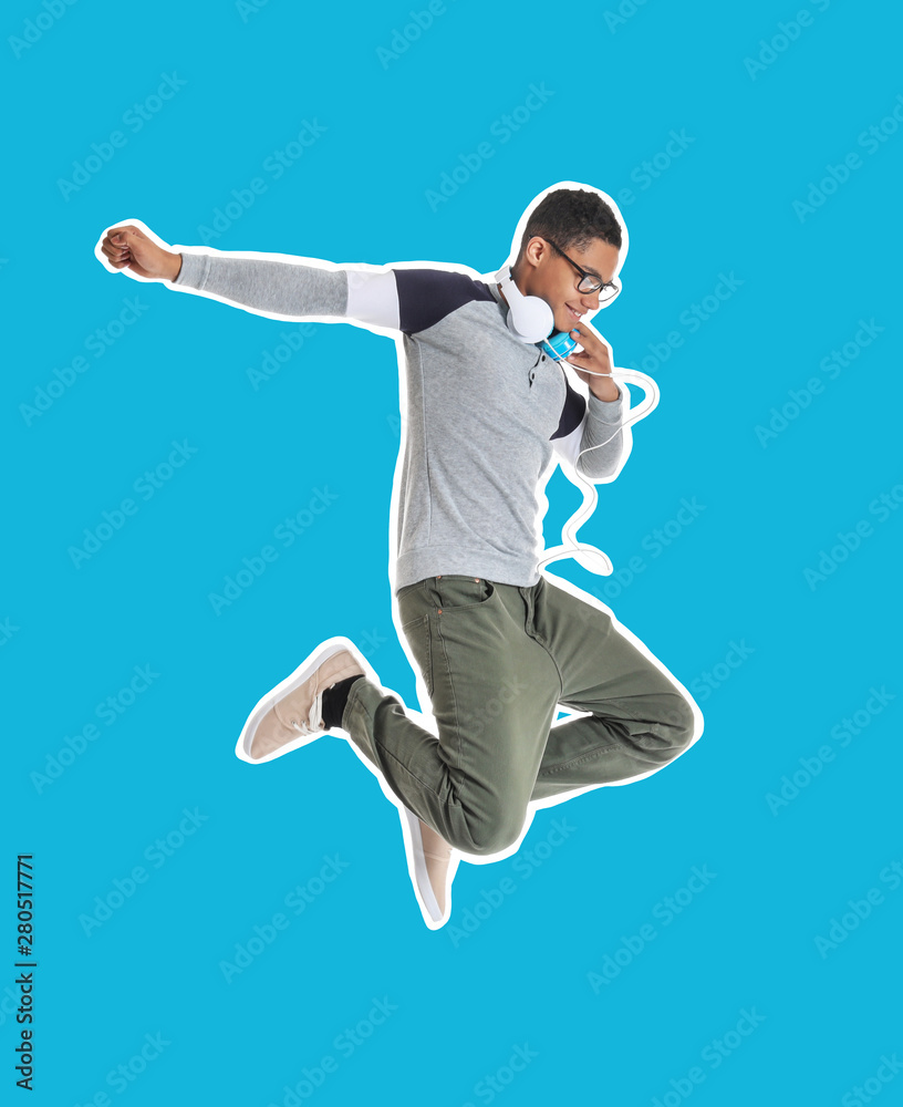 Portrait of jumping African-American teenage boy on white background