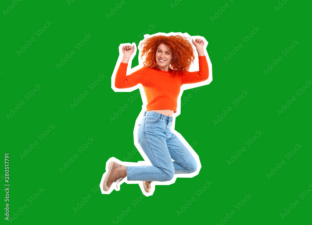 Beautiful jumping redhead woman on color background