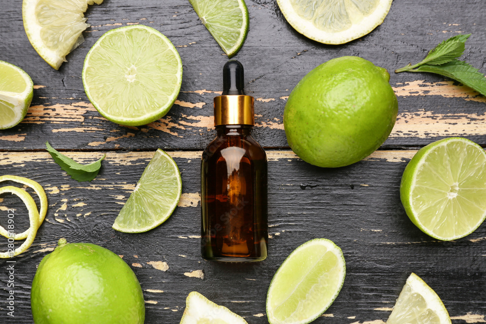 Composition with citrus essential oil on dark wooden background