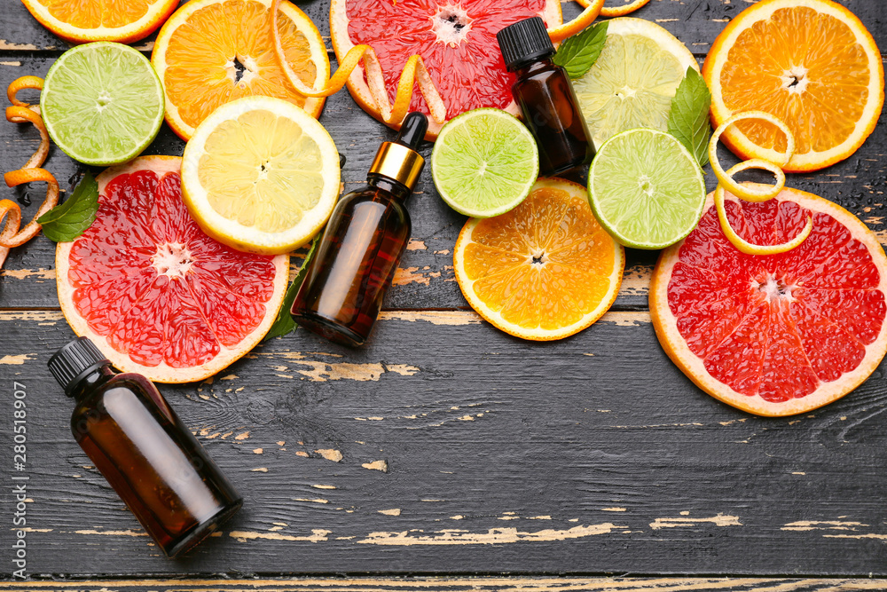 Composition with citrus essential oil on dark wooden background