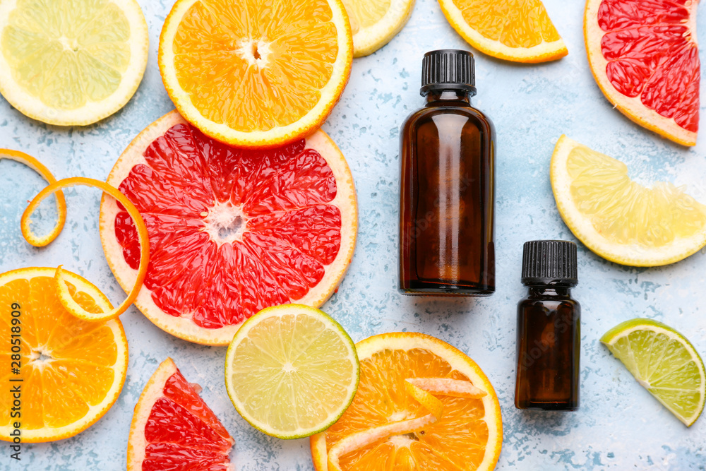 Composition with citrus essential oil on color background