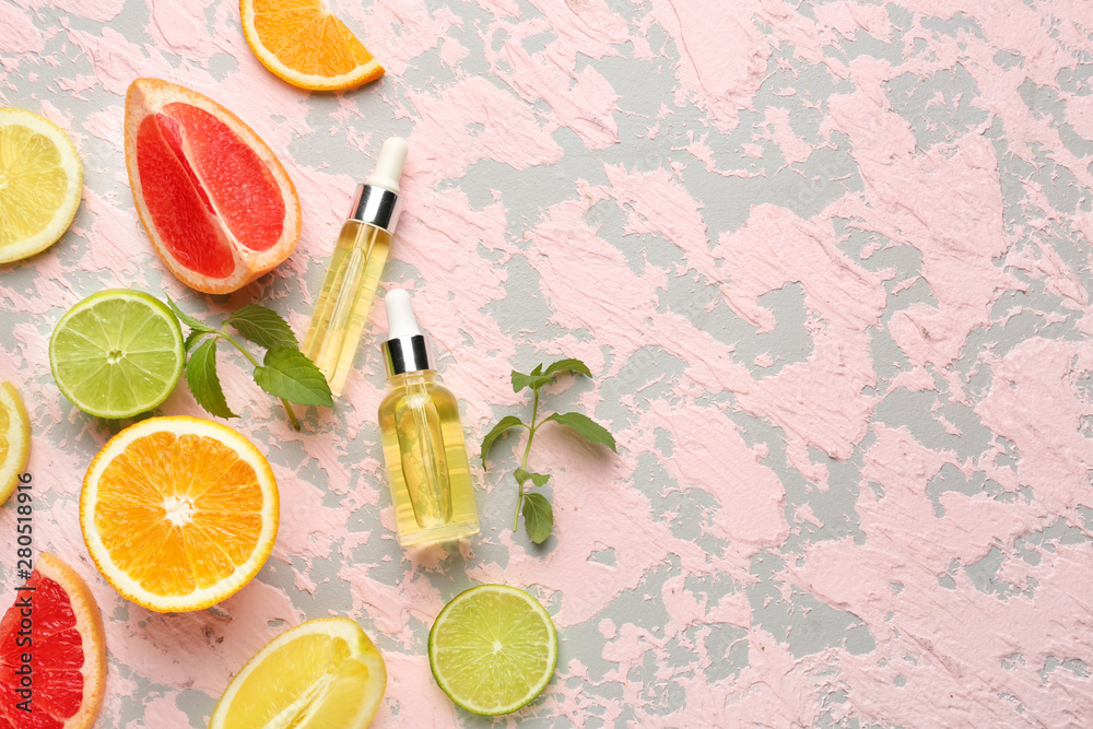 Composition with citrus essential oil on color background