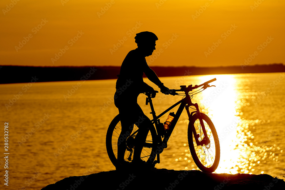 Man cycling at beach on twilight summer season. Active Lifestyle Concept.