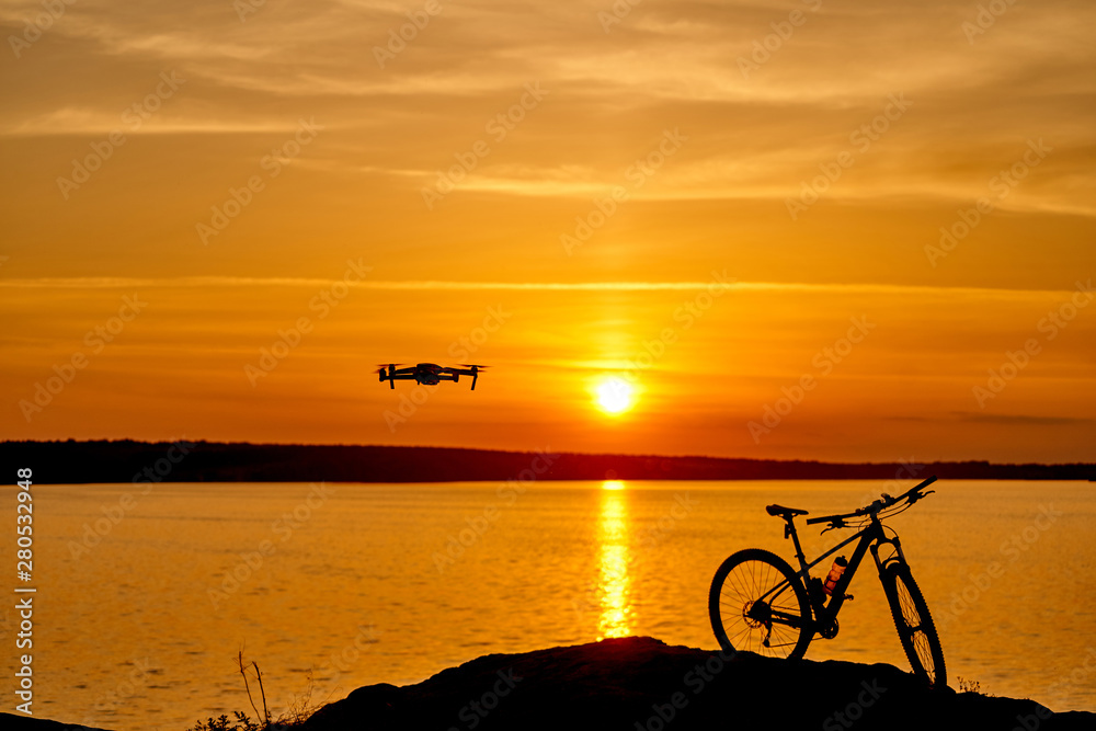 beautiful sunset by the river and the silhouette of a bicycle