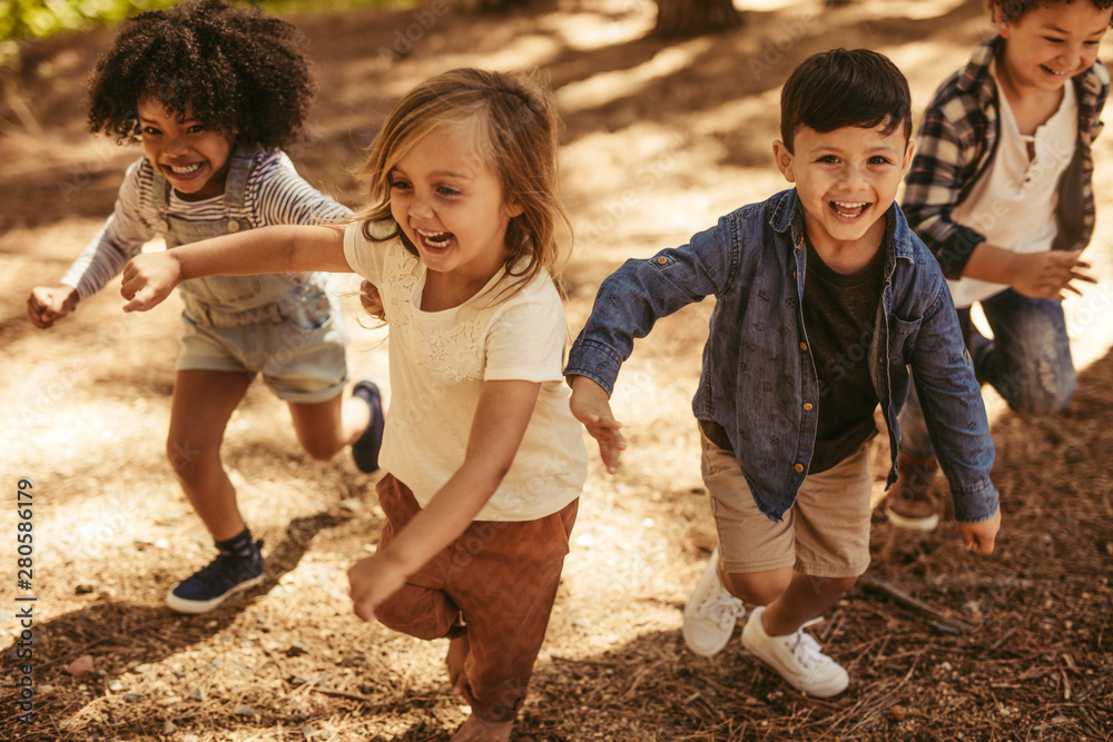 Children playing together in forest