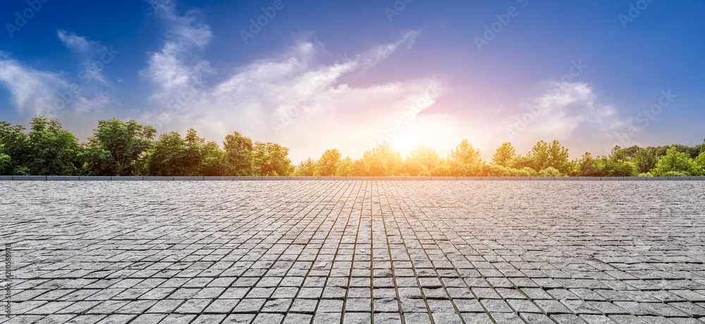 Empty square floor and green forest with beautiful clouds at sunset